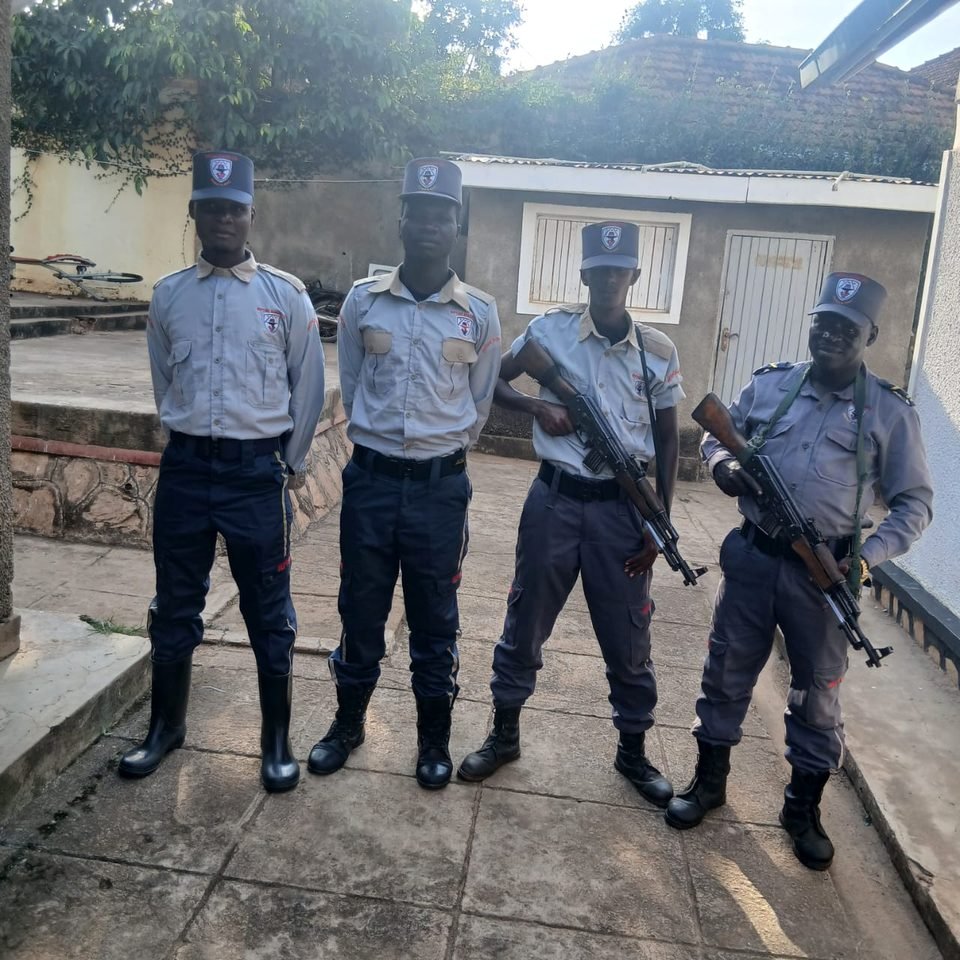 Four Neptune guards in uniform, two carrying slung rifles