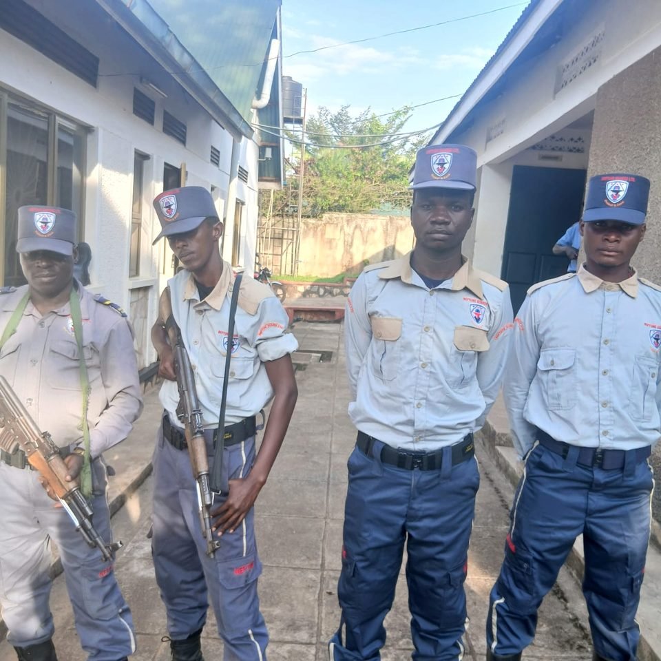 Four Neptune officers standing ready outside a building