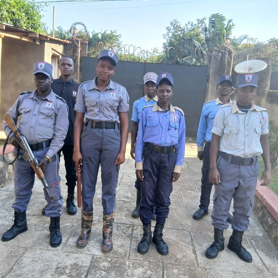 Six Neptune officers lined up in uniform, one armed
